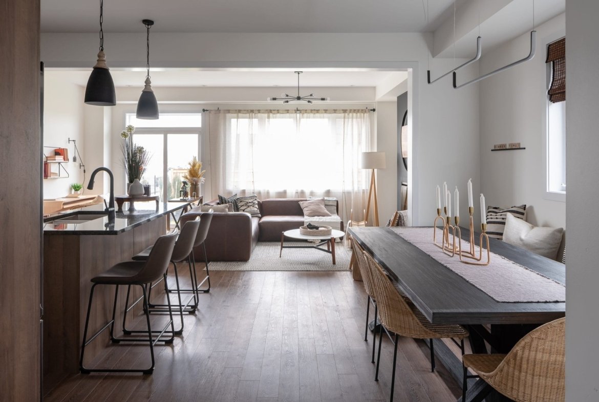Open-concept chef kitchen with quartz countertops and expansive dining area at Empire Calderwood