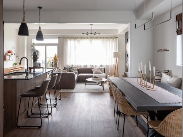 Open-concept chef kitchen with quartz countertops and expansive dining area at Empire Calderwood
