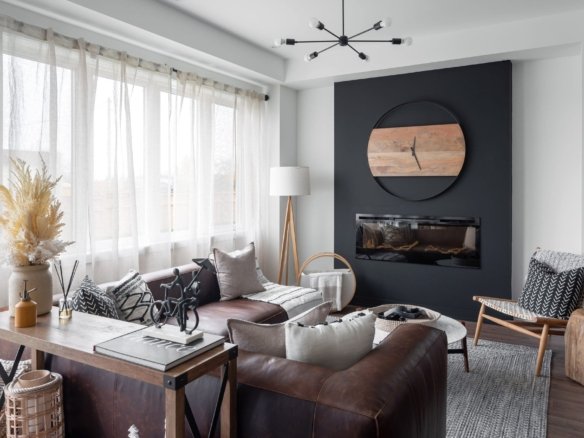 Bright sunlit family living room with large picture windows and hardwood flooring at Empire Calderwood