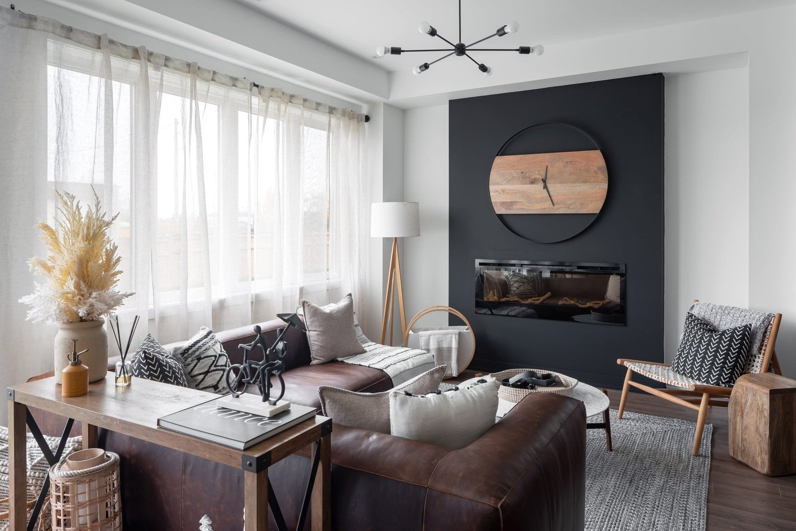 Bright sunlit family living room with large picture windows and hardwood flooring at Empire Calderwood