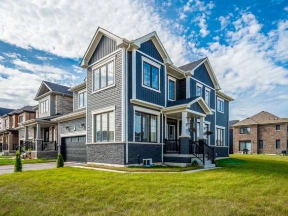 Peaceful family-friendly streetscape with completed homes and tree-lined sidewalks at Empire Calderwood