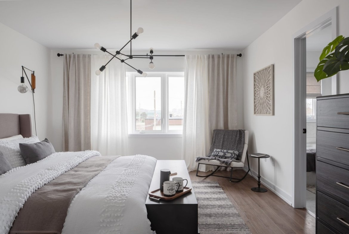 Spacious primary bedroom suite with large walk-in closet and designer finishes at Empire Calderwood