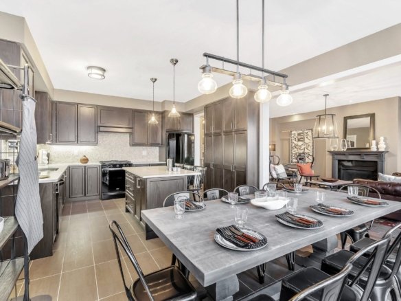 Bright and spacious designer living room featuring expansive windows and hardwood flooring at Empire Legacy