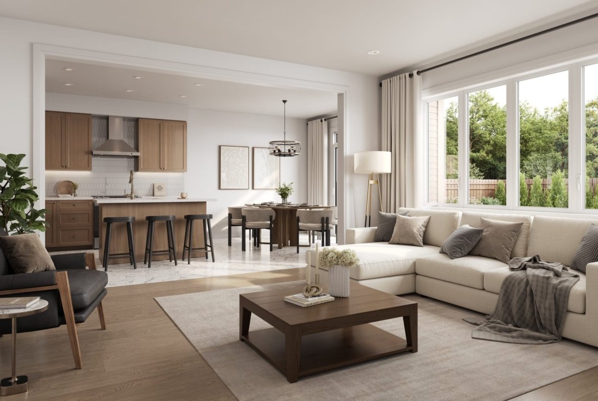Open-concept living space and chef kitchen with quartz countertops and stainless steel appliances at Empire Legacy