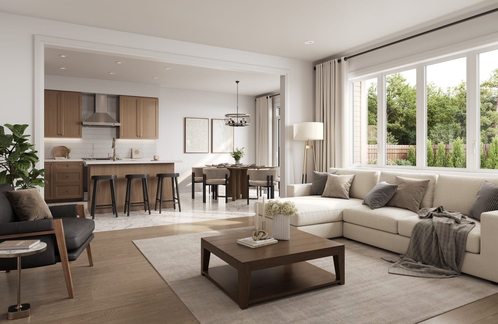 Open-concept living space and chef kitchen with quartz countertops and stainless steel appliances at Empire Legacy